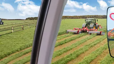 Eine Darstellung des Keyvisuals für das KUHN Herbstrasen 2025 (Frühbezug) mit KUHN-Maschinen und dem Herz.